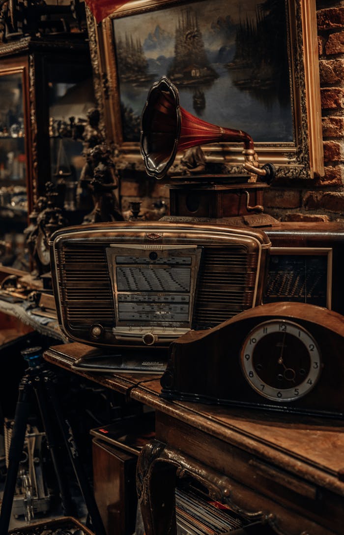 A rustic still life featuring vintage radio, clock, and gramophone.